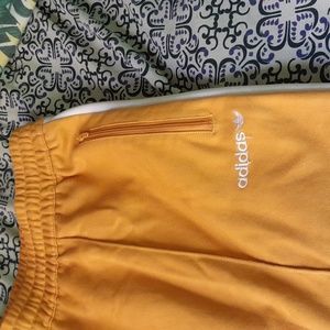 Mens mustard colored Adidas shorts (pockets with zippers),unisex also,size XL